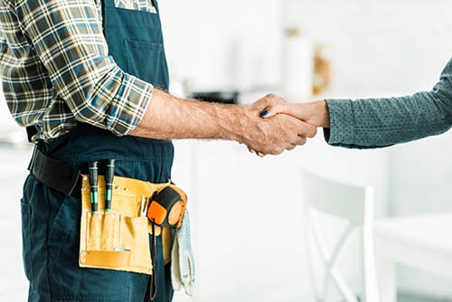 Plumber shaking hands with a client